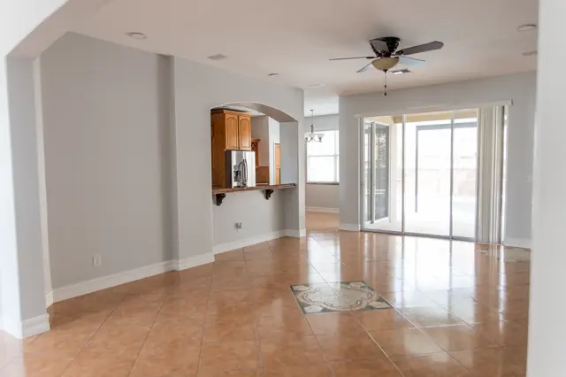 Current condition family room with granite pass-through bar connecting to the kitchen.